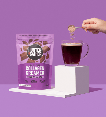 eu-en | Hunter & Gather collagen creamer package with a hand pouring it into a mug of coffee on a purple background.