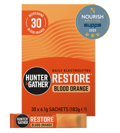 Orange packaging of Hunter & Gather Restore Blood Orange electrolyte supplement with branding and award badge.