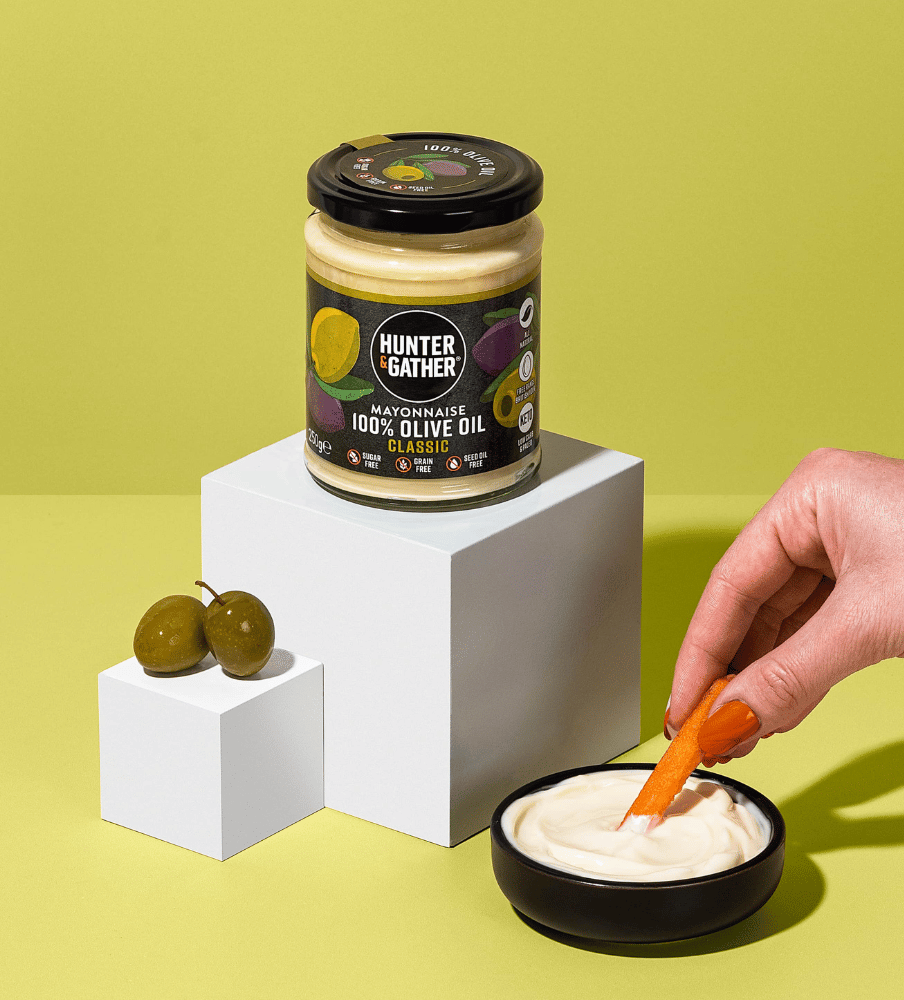 Hunter & Gather mayonnaise jar with a bowl of mayonnaise and a carrot on a green background