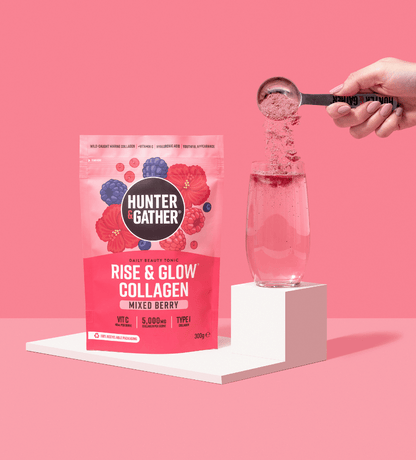 eu-en | Hunter & Gather Rise & Glow Collagen package with a hand pouring powder into a glass on a pink background.